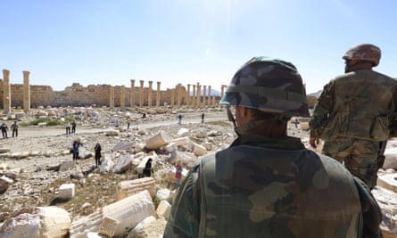 Soldiers, in 2016, look over damage at the Temple of Bel in the historical city of Palmyra in Homs, Syria