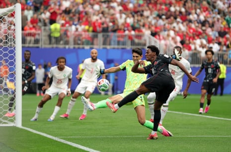 Canada’s Jonathan David shoots against goalkeeper Yassine Bounou