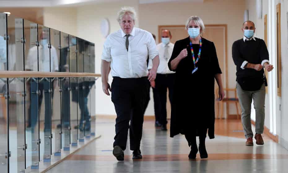 Britain's PM Johnson visits Hexham General hospital without a mask