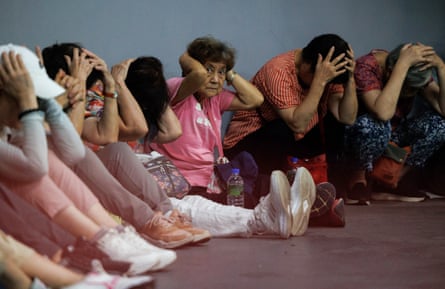 People take shelter in an underground subway station during a simulation attack in Taipei on 13 August 2026.