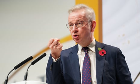 Michael Gove gesturing as he speaks at a podium