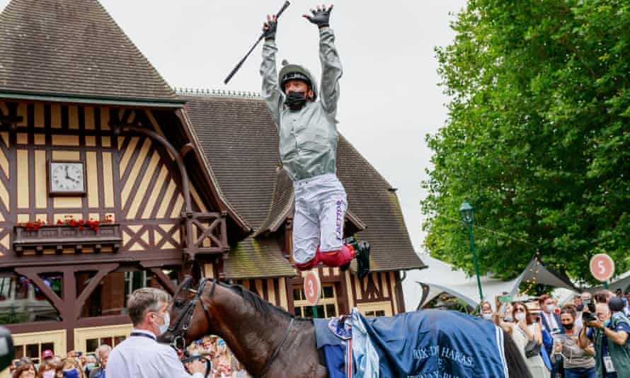 Frankie Dettori celebrates his victory at Deauville with his signature flying takedown.
