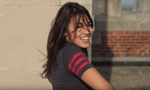 A screen shot of Alexandria Ocasio-Cortez in a high school film dance project 901.png?width=300&quality=85&auto=format