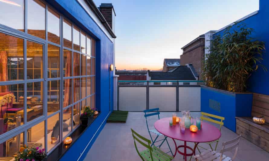 Room with a view: steel-framed glazing opening on to the roof terrace.