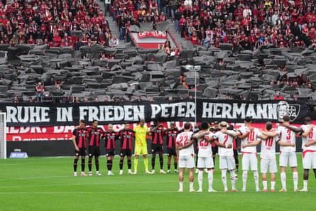 Bayer Leverkusen players and fans hold a minute of silence for Peter Hermann