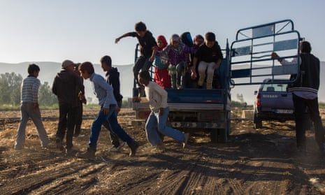 Syrian children refugees jump out of the truck that takes them to work at a farm in Lebanon’s Bekaa valley.