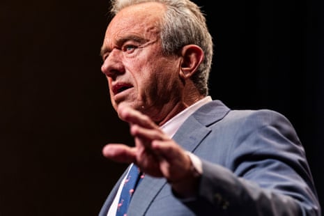 Robert F. Kennedy Jr. gestures with his hand while speaking against a dark background