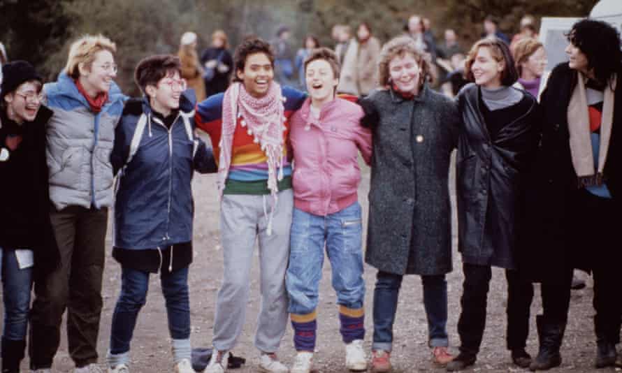 Protesters link arms at Greenham Common in 1983.