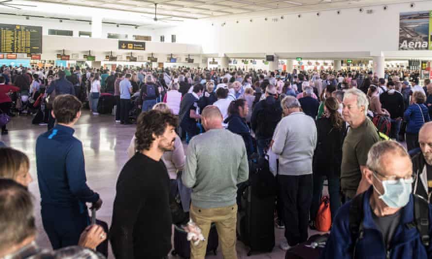 Thousands of tourists wait to board their flights to return to their home countries at Lanzarote Airport in the Canary Islands in Spain.