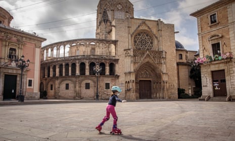 A child skates in a deserted square in Valencia, Spain.