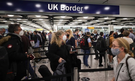 People queueing at Heathrow under a 'UK Border' sign