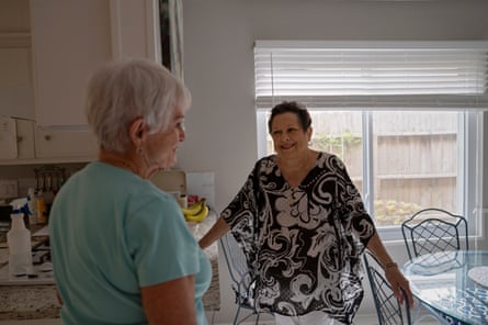 Betsy Lewis, 75, right, talks with a friend at her home in Houston, Texas.