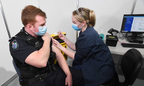 Queensland police Senior Constable Daniel Horne gets the Covid vaccination at Brisbane Entertainment Centre