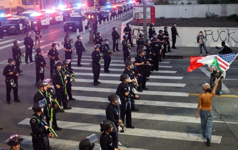 Police enforce the curfew after it went into effect in downtown Los Angeles on Wednesday night.
