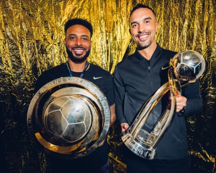 Giles Barnes and Seb Hines with the NWSL shield and championship trophies.