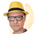 Wayne Koestenbaum, a man in hat and glasses, looks ahead in portrait