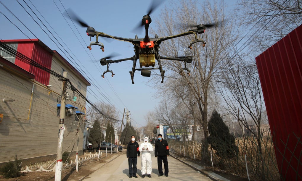Airborne response … a drone sprays disinfectant on streets in China’s Hebei province. Photograph: China Daily/Reuters