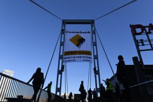 Two activists unveil a banner protesting coal financing by the Commonwealth Bank in Sydney in May.