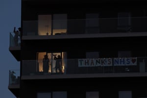 Residents applaud NHS workers from their balconies in Stratford, Newham, east London.