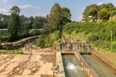Young boys escape the summer heat by playing in a canal downstream from a small dam, in Panauti. Designed to direct water into a small hydroelectric scheme, the system flouts environmental regulations by leaving almost zero flow in the stream bed.