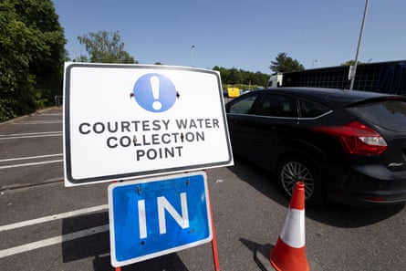 A ‘courtesy water collection point’ sign in a carpark in Kent