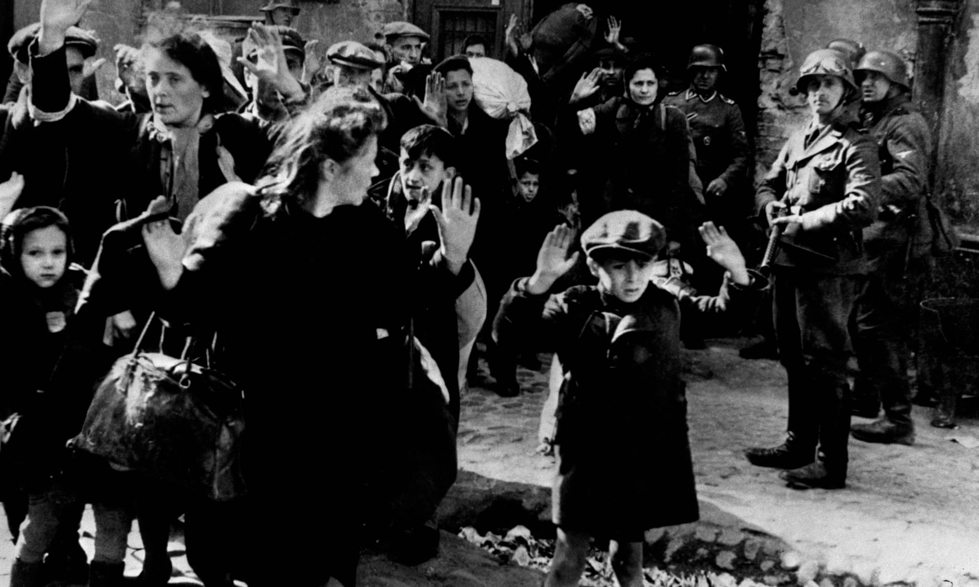 Defeated Jewish families fleeing the Warsaw ghetto in 1943