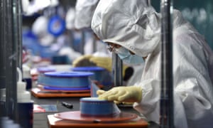 Workers producing adhesive tapes for flexible printed circuits at a factory in Yancheng in China’s eastern Jiangsu province.