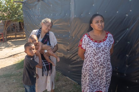 Yurelis Epieyú (right) stands with her family outside her home in La Pista.