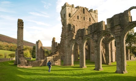 Female tourist in the ruins of Llanthony abbey, Llanthony, Wales