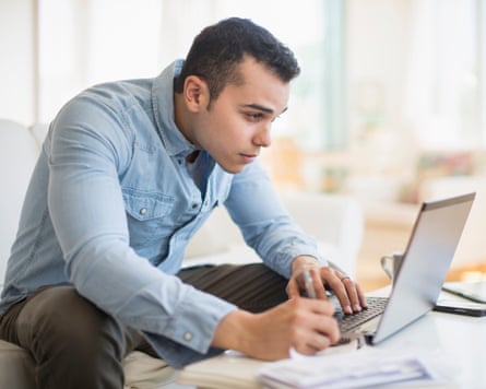 Man working on laptop in living room