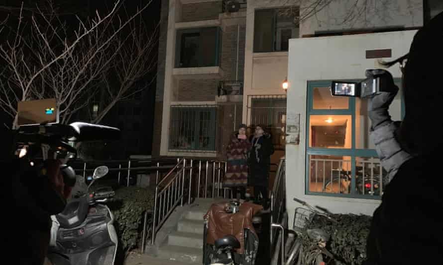 Li Wenzu (left) waits to leave her apartment building in Beijing on Boxing Day to try to attend her husband’s trial.