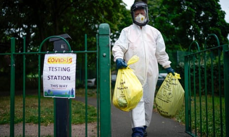 A city council worker carries rubbish from a coronavirus testing centre at Spinney Park in Leicester, England. Hospitalisations as a result of the virus remain low with just 767 patients on 25 August, the lowest since 27 March.