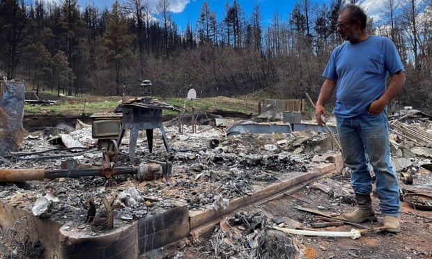 Daniel Encinias stands next to the ruins of his home, destroyed by the Hermits Peak Calf Canyon fire in Tierra Monte, New Mexico.
