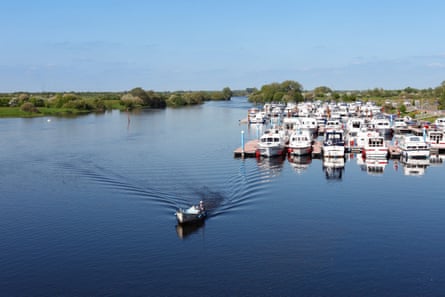 Broad river and boats in flat scenery