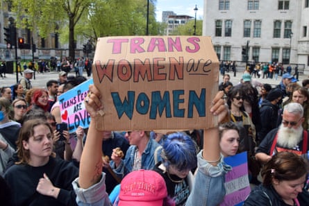 Crowd of people in central London with someone holding up a sign that says ‘Trans women are women’