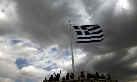 A Greek national flag atop the archaeological site of the Athens Acropolis.