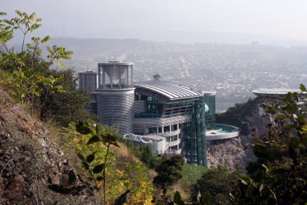 A modernist steel and glass palace including pool and helipad set into a promontory overlooking Tbilisi
