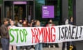 Protesters gather outside the Nancy Rothwell building at Manchester University.