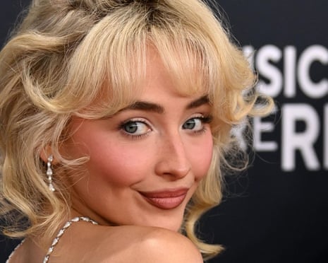 A blonde pop star smiles