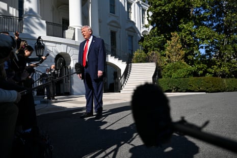 man in suit speaks outside to reporters