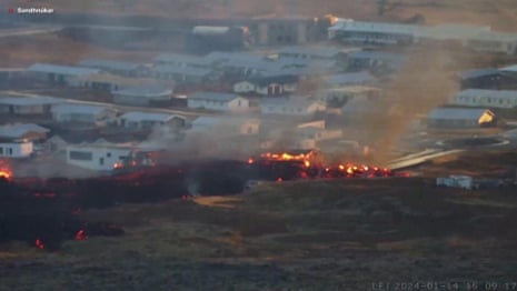 Buildings on fire after volcano erupts in southwest Iceland – video