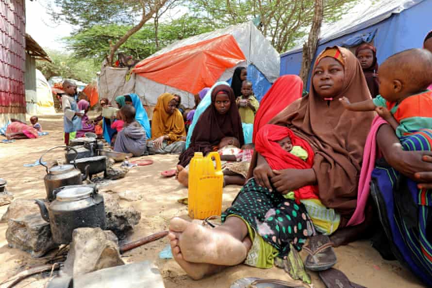 Somali families, displaced after fleeing the Lower Shabelle region after an uptick in US airstrikes, rest at an internally displaced person camp near Mogadishu, Somalia on 12 March 2020.