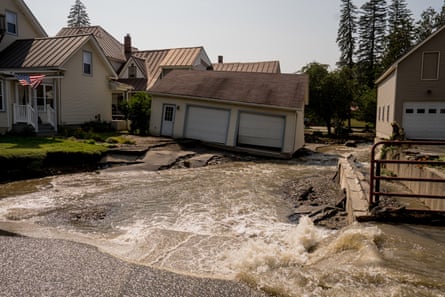 Damaged home sinking from flash flooding amid pooling water in the driveway