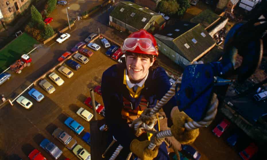▲ An apprentice steeplejack gets to work in Kings Lynn, Norfolk photograph: GettyA young apprentice stop near the top of a city centre chimney during a steeplejack course in Kings Lynn, Norfolk. Using an elaborate system of harnesses and pulleys, the young lad is learning the skills to work safely and efficiently at dangerous heights and the town stretches below. Sponsored training is offered through the Steeplejack Industry Training Group Association and CITB-ConstructionSkills for young people aged 16. Applicants for this scheme will have to pass aptitude tests, literary a (Photo by In Pictures Ltd./Corbis via Getty Images)