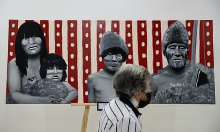 A woman looks at a painting representing members of the Selk’nam people in Santiago, Chile, in February.