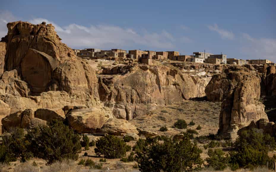 Pueblo style homes blend in to the edge of a rocky south-western mesa.