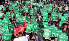 Demonstrators carry flags and banners during a protest in Amman, Jordan, in support of Palestinians in Gaza, amid the ongoing conflict between Israel and the Palestinian Islamist group Hamas