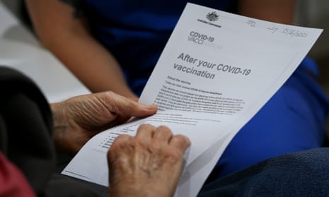 A patient looks at an information pack ahead of receiving the Covid-19 AstraZeneca vaccine at a GP in Sydney. Overnight the EU drug regulator said that rare blood clots would be listed formally as a side-effect of the AstraZeneca jab. 