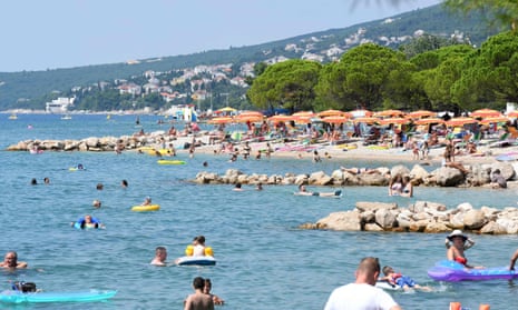 CROATIA-HEALTH-VIRUS-TOURISMPeople, mostly foreign tourists, sunbath and swim on 13 August, 2020, in Crikvenica on the northern Adriatic coast. (Photo by DENIS LOVROVIC/AFP via Getty Images)