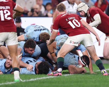 Ethan Dobbins scores a try for the Waratahs from a pile of bodies